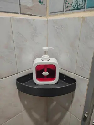 a red and white toaster sitting on a black shelf at 204 Olan Place Spacious Studio with Wi-fi near BTS Skytrain in Bangkok