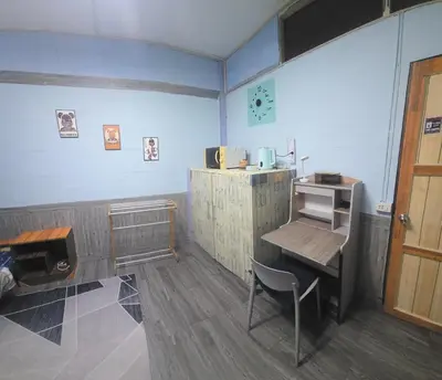 a room with a desk and a table and a chair at 204 Olan Place Spacious Studio with Wi-fi near BTS Skytrain in Bangkok
