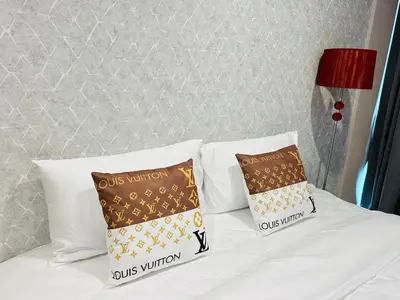 a bed with two pillows on top of it at New Ekamai Thonglor Luxury Home near 711, BTS, Mall in Khlong Toei