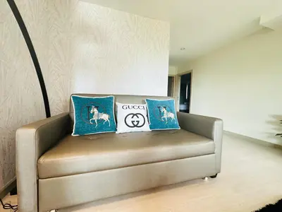 two pillows on a leather couch in a living room at New Ekamai Thonglor Luxury Home near 711, BTS, Mall in Khlong Toei