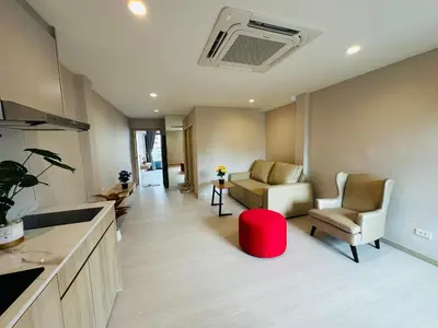 a room with two chairs and a red stool at New Ekamai Thonglor Luxury Home near 711, BTS, Mall in Khlong Toei