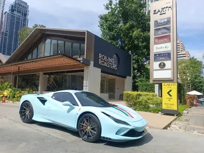 a white sports car parked in front of a building at New Ekamai Thonglor Luxury Home near 711, BTS, Mall in Khlong Toei