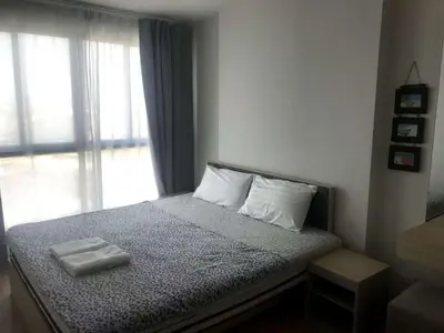 a bedroom with a bed with two towels on it at Owow o2 in Bang Chak