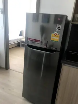 a refrigerator with a sticker on it in a kitchen at Owow o2 in Bang Chak