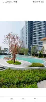a tree in a park with buildings in the background at Owow o2 in Bang Chak