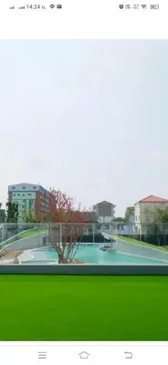 a picture of a swimming pool with green grass at Owow o2 in Bang Chak