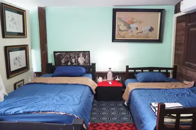 a bedroom with two beds and a red table at 64 Sweet Home Dusit BKK in Bangkok