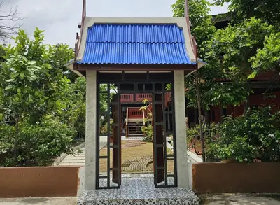 a small building with a blue roof on top of it at Nipatra Homestay in Ban Khlong Bang Sai