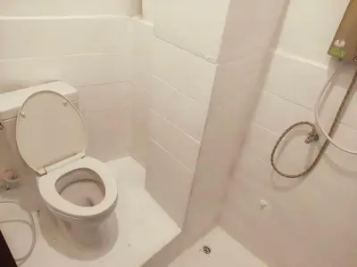 a white bathroom with a toilet and a shower at XX GO INN Asiatique BKK Charoen krung- โกอินน์ เอเซียทีค เจริญกรุง in Godown