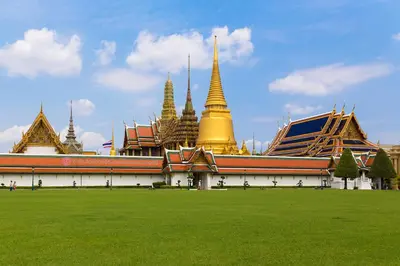 a large building with a green field in front of it at XX GO INN Asiatique BKK Charoen krung- โกอินน์ เอเซียทีค เจริญกรุง in Godown