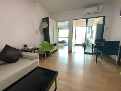a living room with a couch and a table at Home at Sena in Bangkok