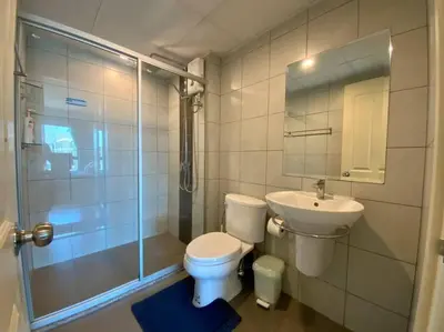 a bathroom with a toilet and a sink and a shower at Home at Sena in Bangkok