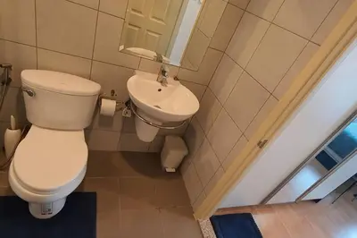 a bathroom with a toilet and a sink at Home at Sena in Bangkok