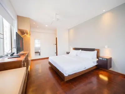a bedroom with a bed and a television in it at home22 Private Residence in Bangkok