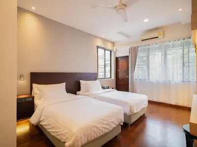 a bedroom with two beds and a window at home22 Private Residence in Bangkok