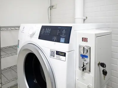 a white washing machine sitting next to a machine at home22 Private Residence in Bangkok