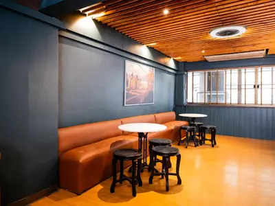 a waiting room with a couch and tables at home22 Private Residence in Bangkok