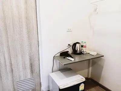 a room with a table with a tea kettle on it at xx HD Yaowarat Road BKK in Samphanthawong