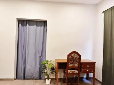 a chair and a desk in a room with a window at xx HD Yaowarat Road BKK in Samphanthawong