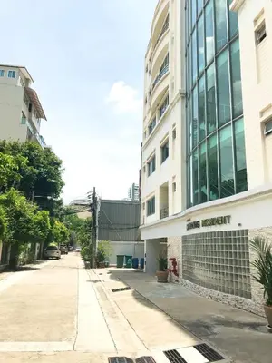 an empty street in front of a building at Charming Resident Sukhumvit 22 in Bangkok