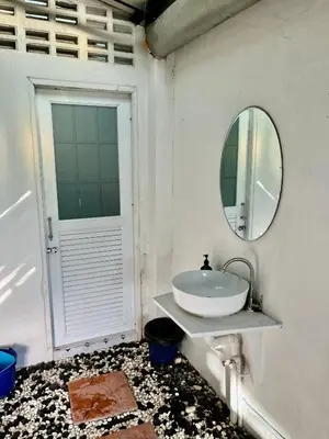 a bathroom with a sink and a mirror at Kirin Riverside Homestay with AC, WiFi in Bangkok in Rat Burana