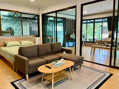 a living room with a couch and a table at Kirin Riverside Homestay with AC, WiFi in Bangkok in Rat Burana