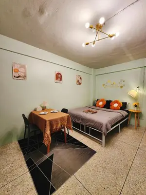 a bedroom with a bed and a table in it at 805-STP Homely room Free Wi-Fi and Near BTS line in Bangkok