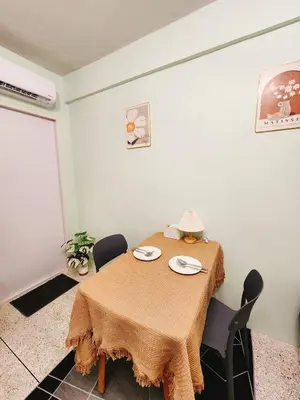 a dining room table with two chairs and a brown table cloth at 805-STP Homely room Free Wi-Fi and Near BTS line in Bangkok