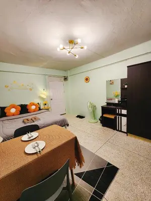 a room with a bed and a table and a bed and a television at 805-STP Homely room Free Wi-Fi and Near BTS line in Bangkok
