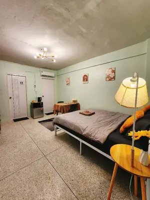 a bedroom with a bed and a table with a lamp at 805-STP Homely room Free Wi-Fi and Near BTS line in Bangkok