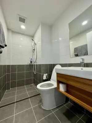 a bathroom with a toilet and a sink at Modern Condo Near Icon Siam & BTS Krung Thonburi in Bangkok