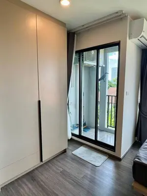 a living room with a sliding glass door and a room with at Modern Condo Near Icon Siam & BTS Krung Thonburi in Bangkok