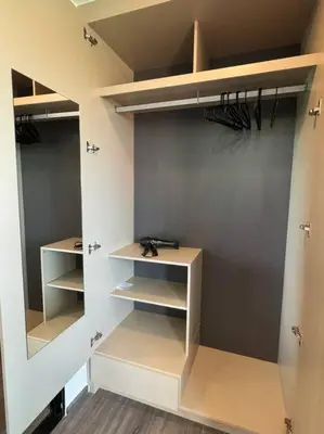 a walk in closet with white shelving and shelves at Modern Condo Near Icon Siam & BTS Krung Thonburi in Bangkok