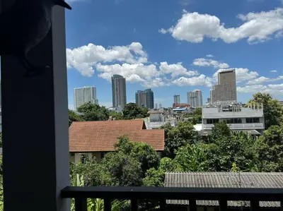 a view of a city skyline from a balcony at Modern Condo Near Icon Siam & BTS Krung Thonburi in Bangkok