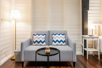 a living room with a couch and a table at Resort Bangphlat in Bang O