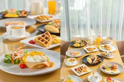 a table with plates of breakfast food on it at Resort Bangphlat in Bang O