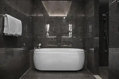 a bathroom with a large white tub and a shower at Marriott Executive Apartments, Bangkok Townhall Sukhumvit in Bangkok