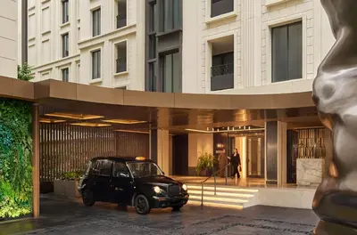 a black car parked in front of a building at Marriott Executive Apartments, Bangkok Townhall Sukhumvit in Bangkok