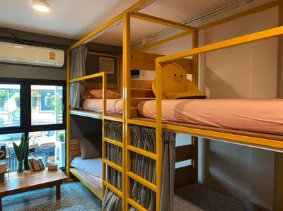 a bunk bed room with two bunk beds and a desk at The Space Hometel - Women Only in Pom Prap