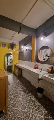 a bathroom with a sink and a mirror at The Space Hometel - Women Only in Pom Prap