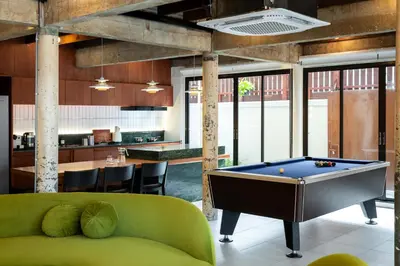a pool table in the middle of a room at Baan Jila in Bangkok