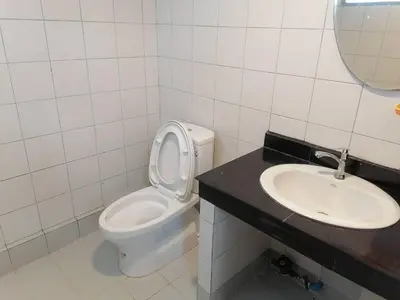 a bathroom with a toilet and a sink at Merlin MANSION 107 in Ban Khlong Samrong
