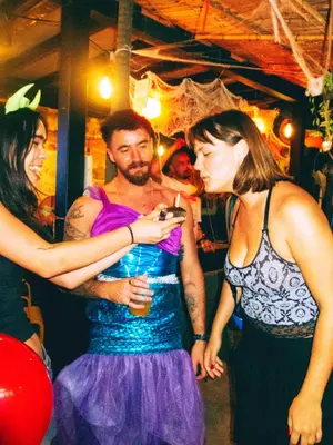 a group of people dancing at a party at AREA81 HIDEOUT Hostel Khaosan in Bangkok