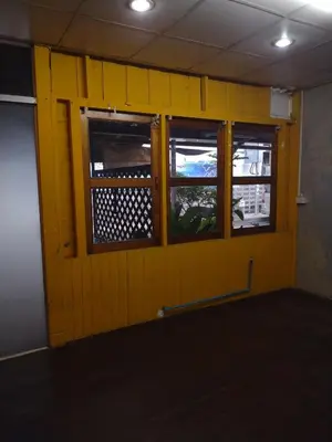 a yellow wall with two windows in a room at 362 สวนอ้อย5 in Dusit