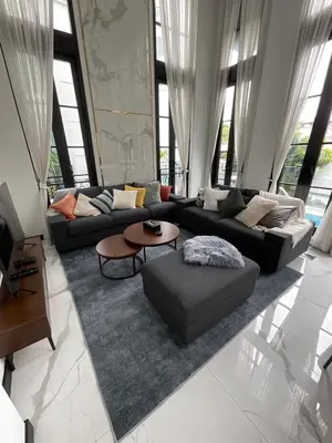 a living room with two couches and a rug at Luxury Pool Villa 5BR 12pax with Private Lift in Ekkamai in Bangkok
