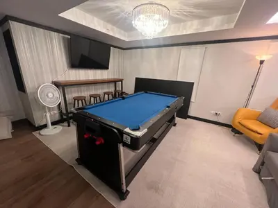 a living room with a pool table in it at Luxury Pool Villa 5BR 12pax with Private Lift in Ekkamai in Bangkok