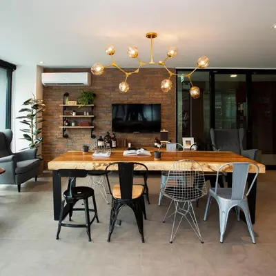 a dining room with a large wooden table and chairs at Parrish Serviced Apartment in Bang Mote