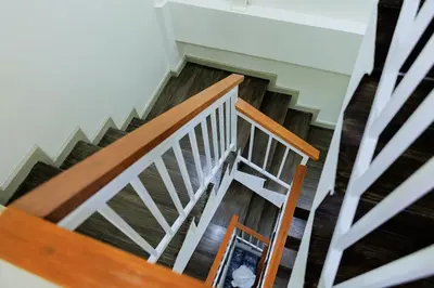 an overhead view of a wooden stairs with a mirror at Reezq Hostel in Ban Khlong Bang Sai