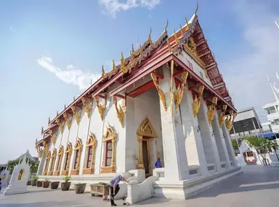 a building with a person sitting in front of it at GO INN Siriraj - โกอินน์ ศิริราช Pro in Bangkok Noi