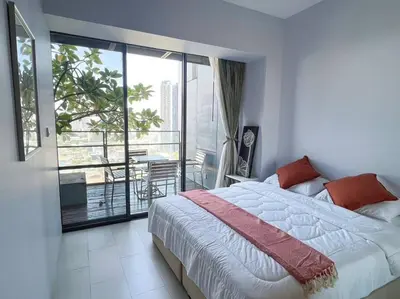 a bedroom with a large bed and a balcony at Resort Living 2BR - Ultra Fast Wifii - BTS Chong Nonsi in Bangkok